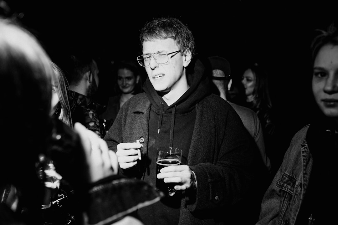 man in black hoodie wearing eyeglasses