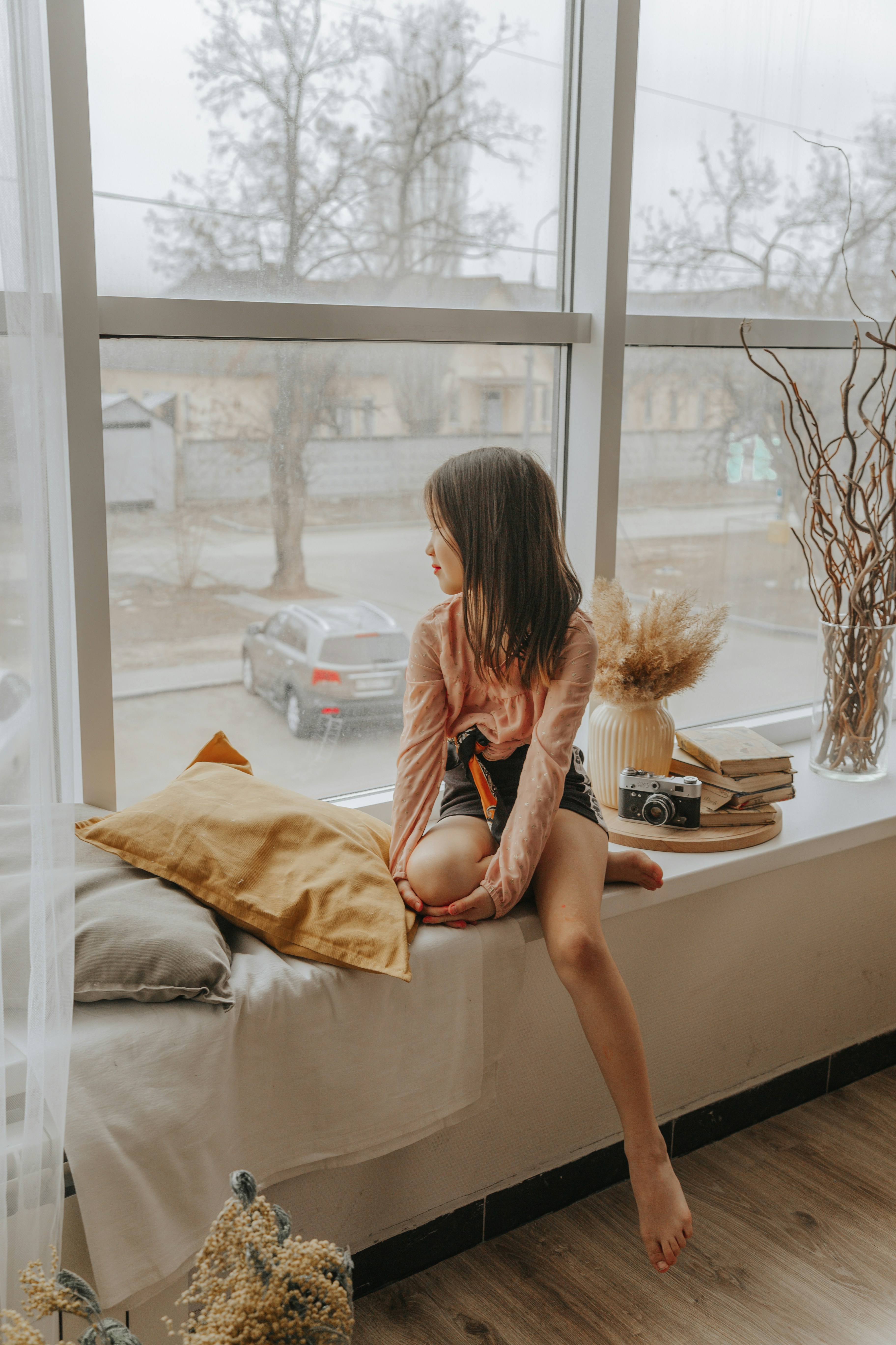 woman in red dress sitting on bed