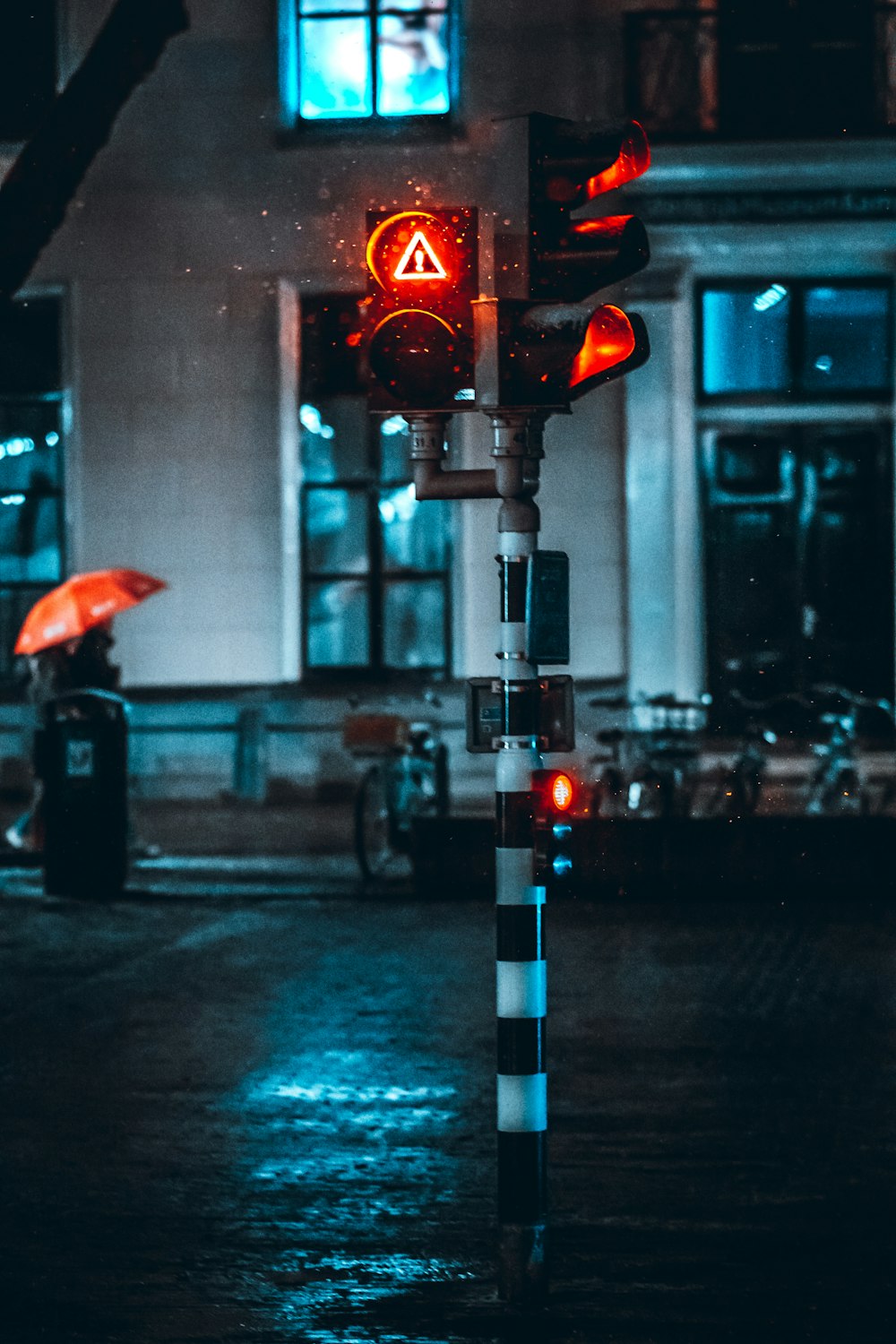 red umbrella on traffic light