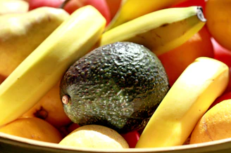 Close-up of vibrant mango and banana fruit powders neatly displayed in wooden bowls.