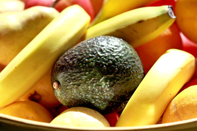 Close-up of vibrant mango and banana fruit powders neatly displayed in wooden bowls.