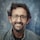 man in gray denim jacket wearing black framed eyeglasses