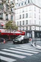 A learner driver taking a practical driving test in a European city setting.