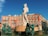 man statue near brown building during daytime