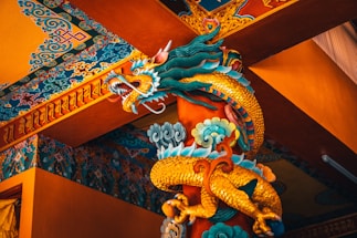 blue dragon figurine on brown wooden table