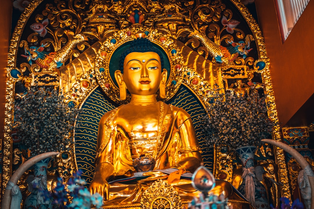 gold buddha statue with blue and gold background