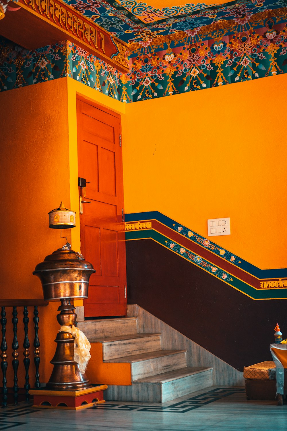 brown wooden staircase near orange wall