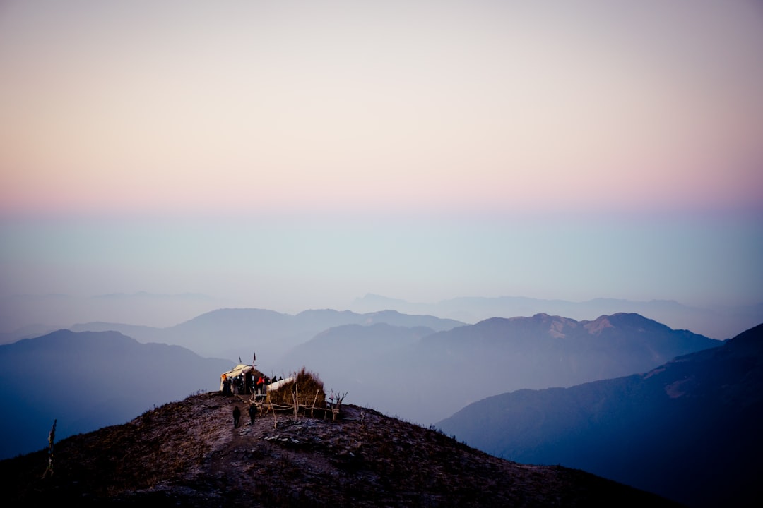 person standing on rock mountain during daytime