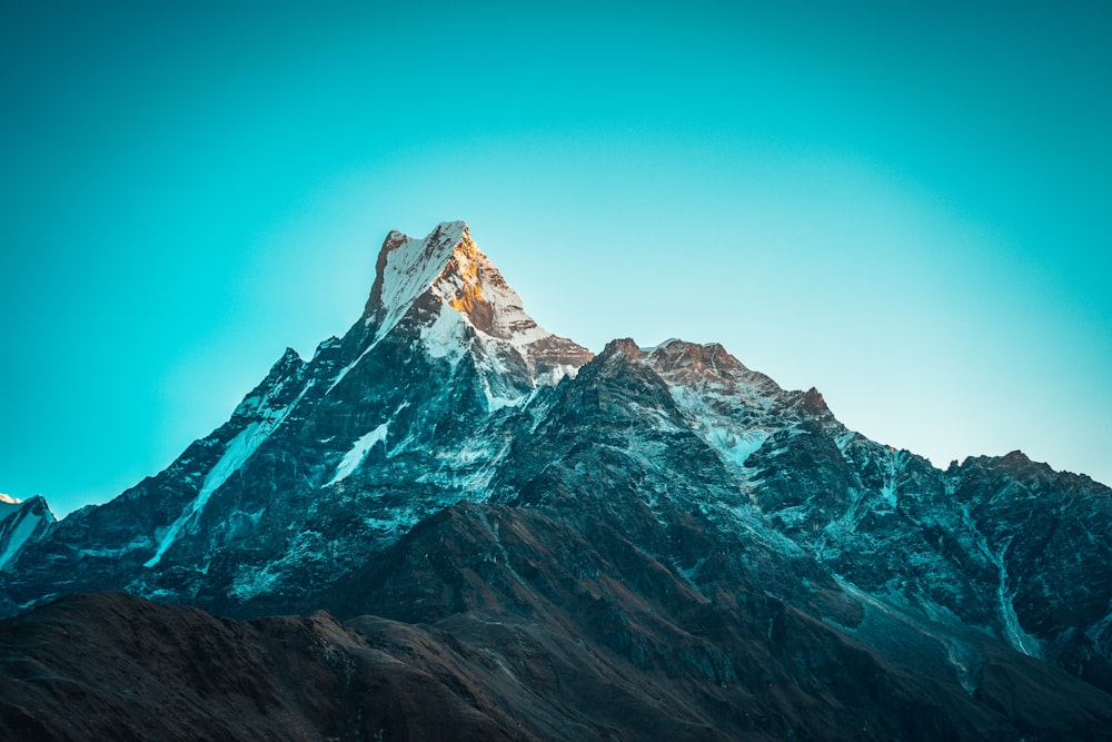 snow covered mountain under blue sky during daytime