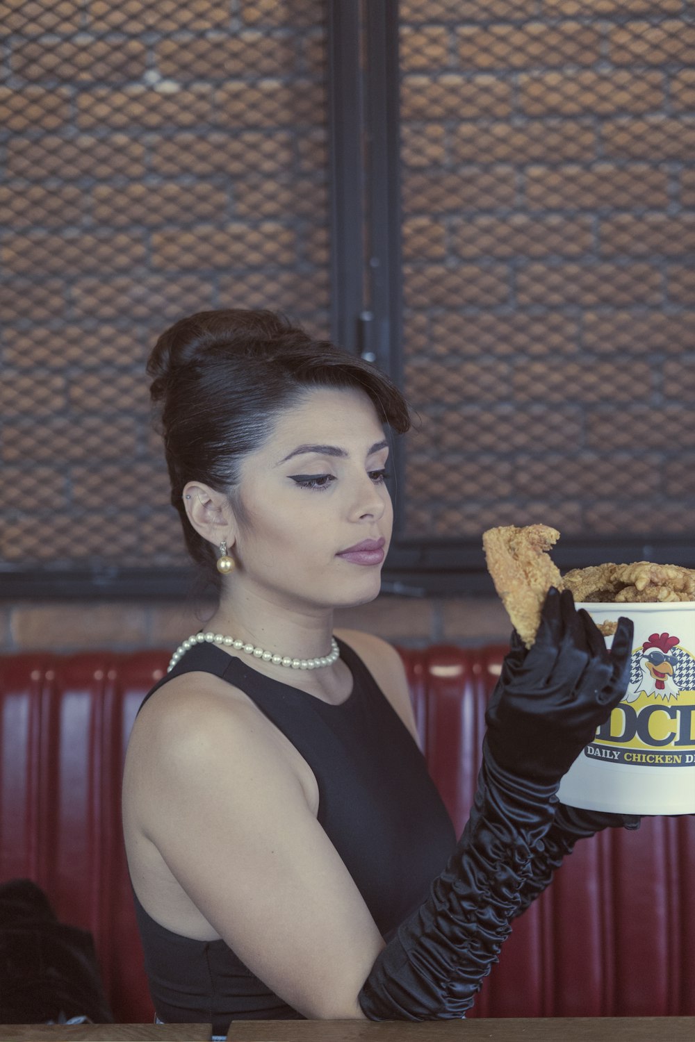 woman in black tank top holding burger