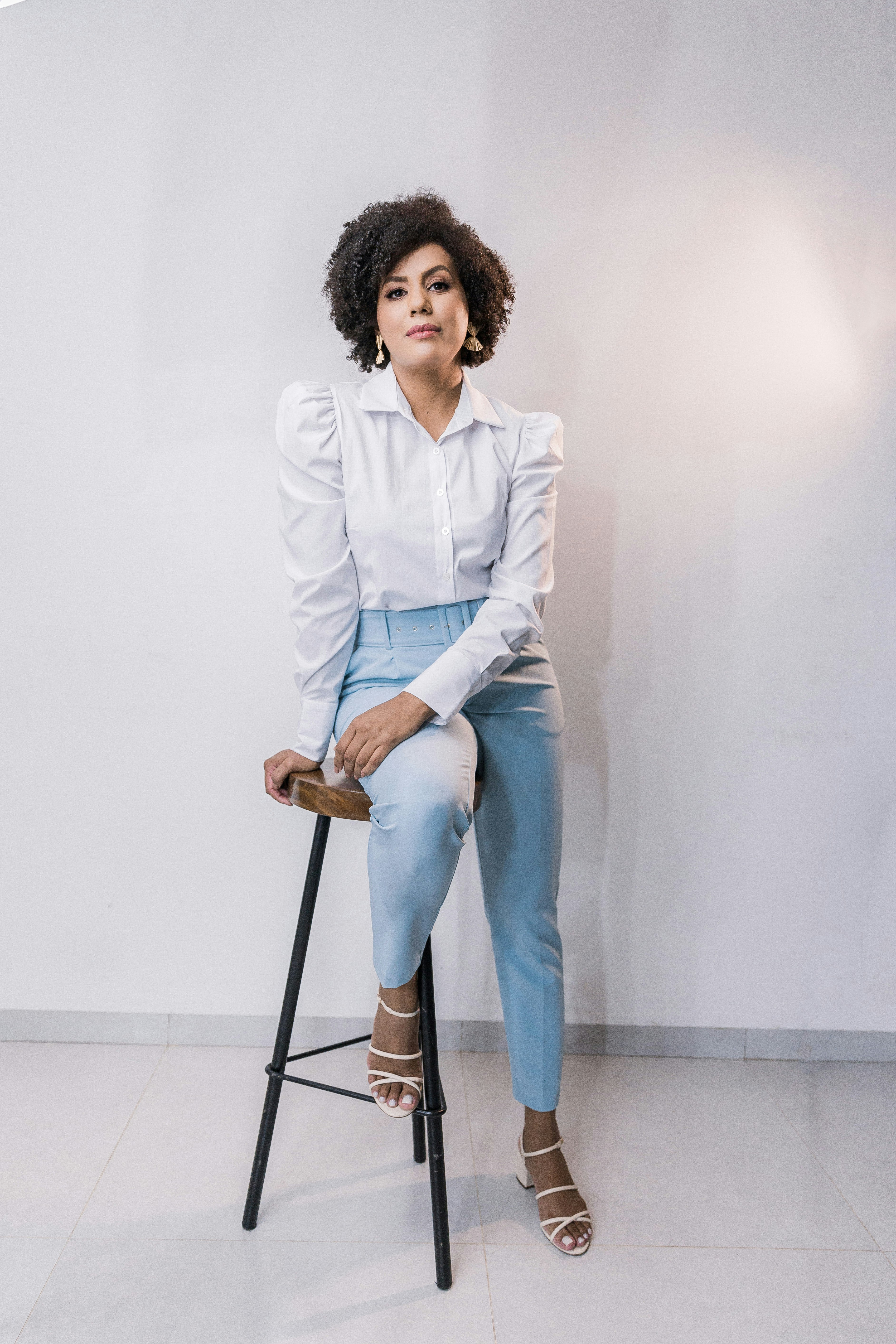 woman in white dress shirt and blue denim jeans