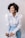 woman in white dress shirt and blue denim jeans smiling