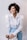woman in white dress shirt and blue denim jeans smiling