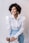 woman in white dress shirt and blue denim jeans smiling