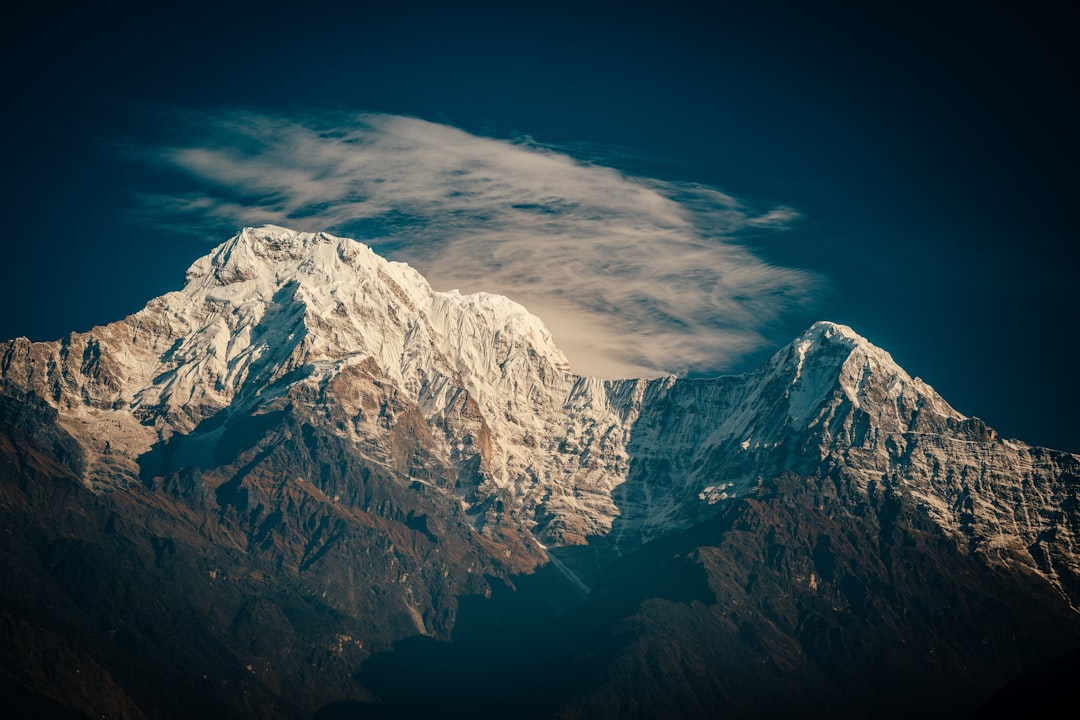 snow covered mountain under cloudy sky during daytime