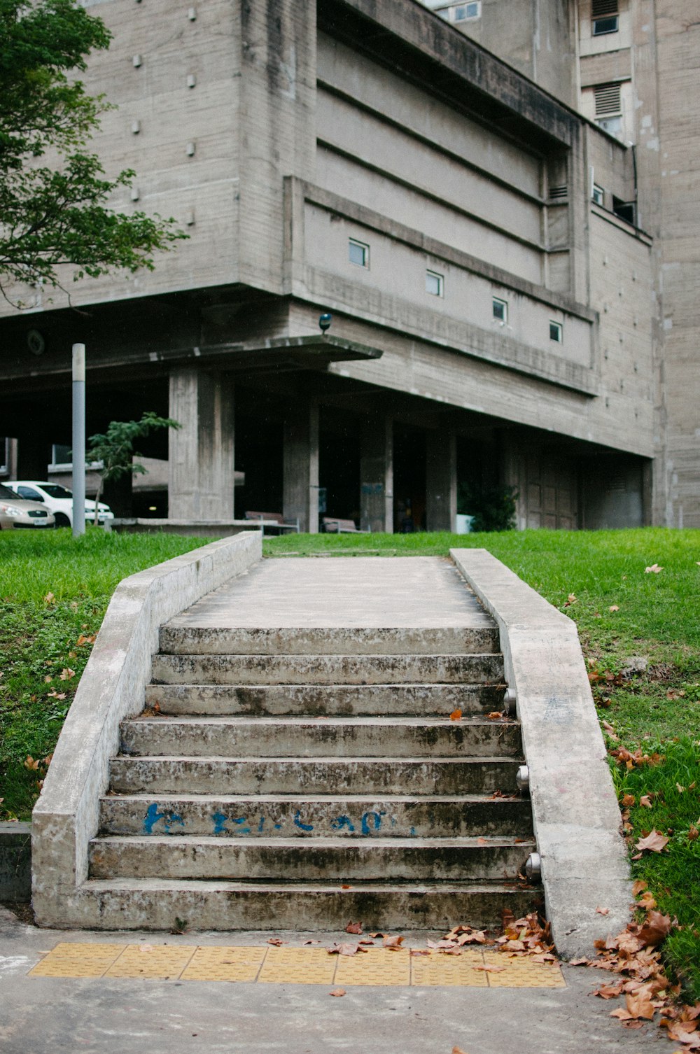 gray concrete stairs near green grass field during daytime