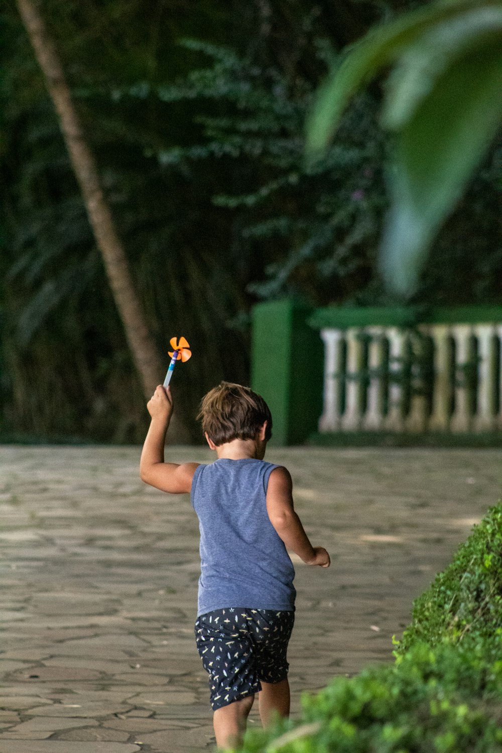 girl in gray tank top and blue denim shorts holding lighted sparkler