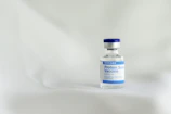 Photo of a vial with a detailed, compliant technical label showing braille and FDA guidelines.