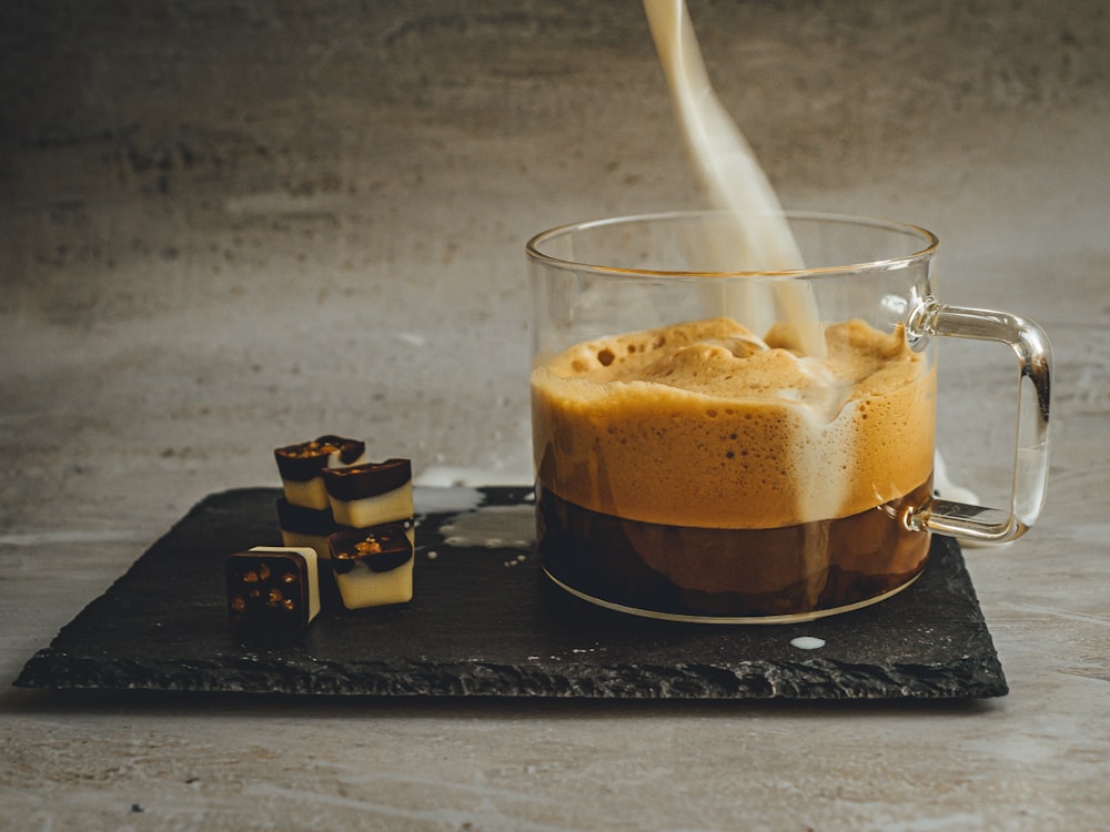 clear drinking glass with brown liquid