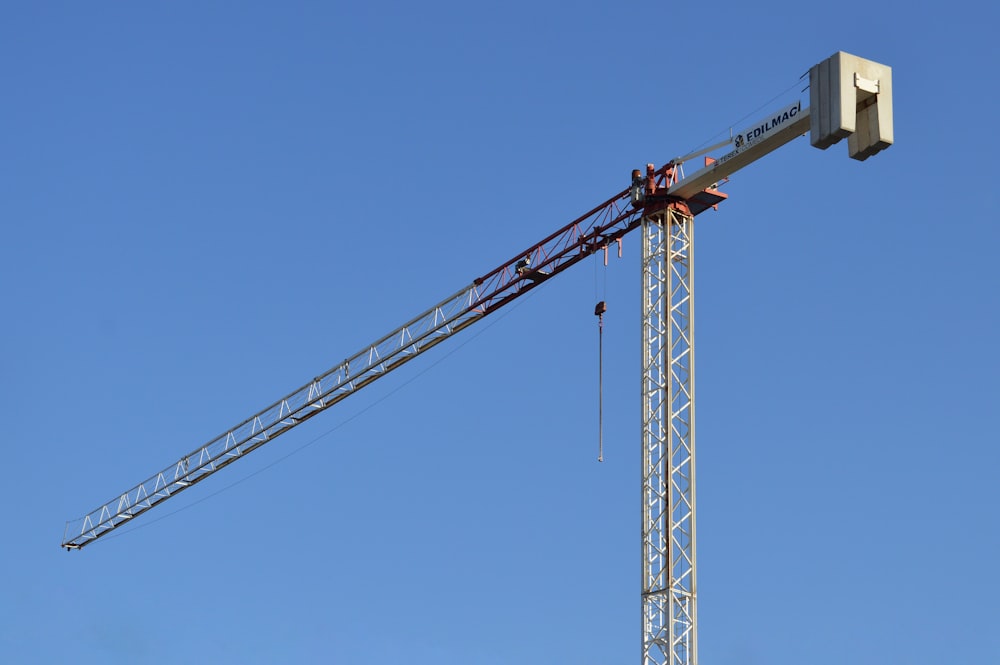 yellow crane under blue sky during daytime