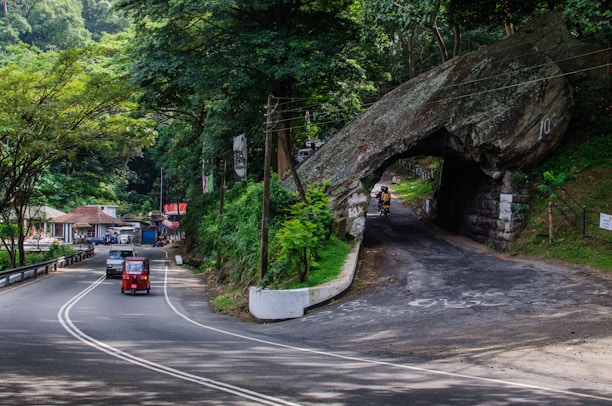 A scenic road winding through Tamil Nadu with a motorbike and car ready for adventure.