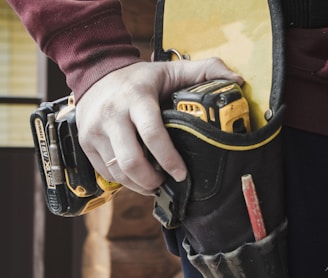 person holding black and yellow nike gloves