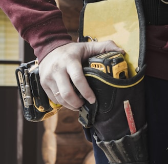 person holding black and yellow nike gloves