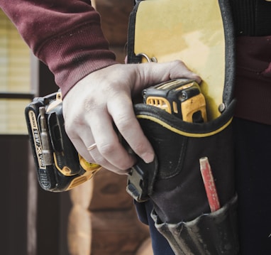 person holding black and yellow nike gloves