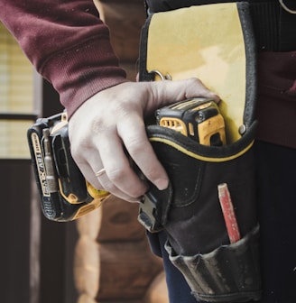 person holding black and yellow nike gloves