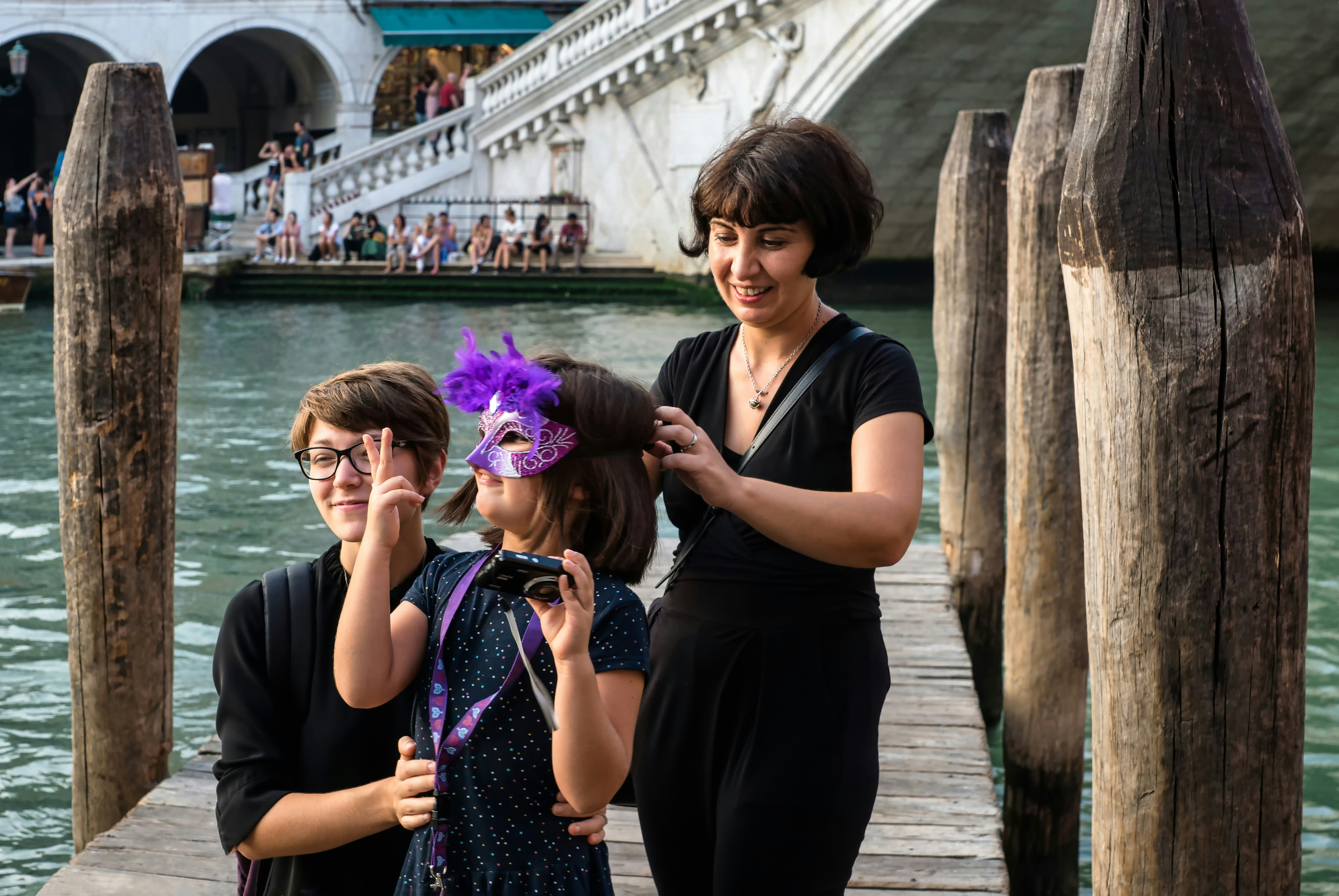 woman in black dress with purple flower on her ear