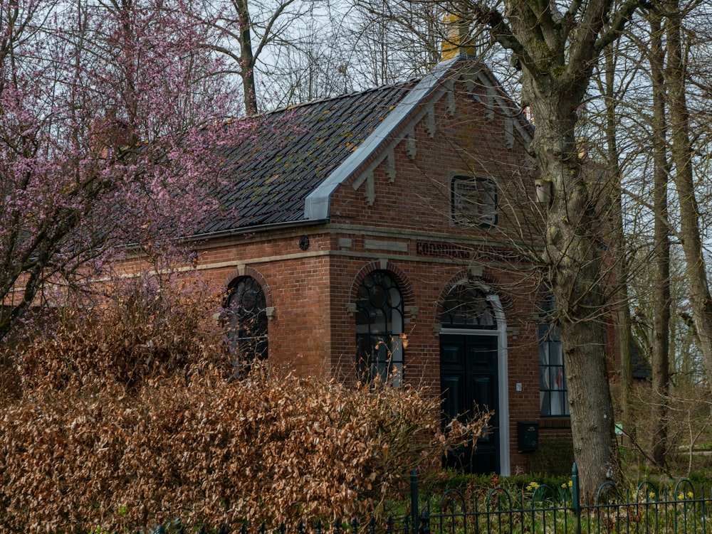 brown and gray concrete house near brown trees during daytime