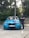 A happy customer standing next to their new car.