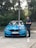 A happy customer standing next to their new car.