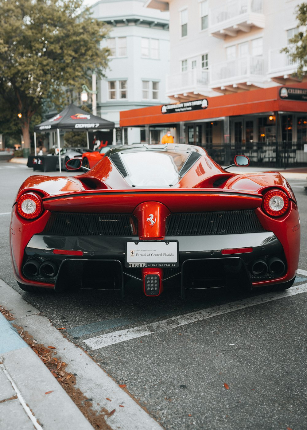 red ferrari 458 italia on road during daytime