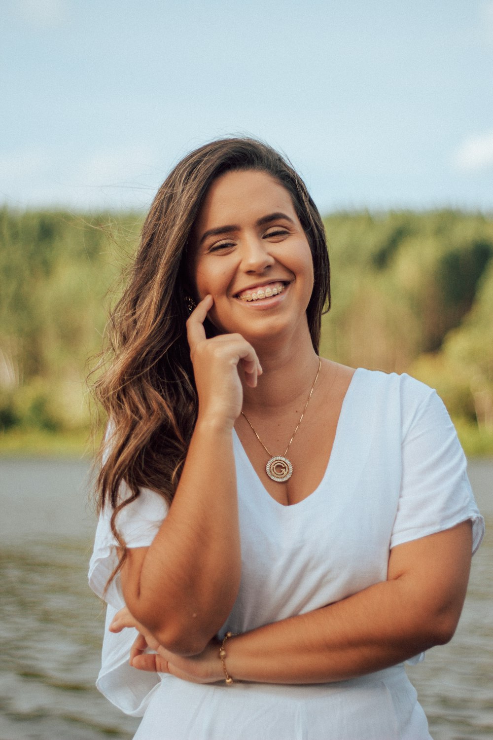 woman in white scoop neck shirt smiling