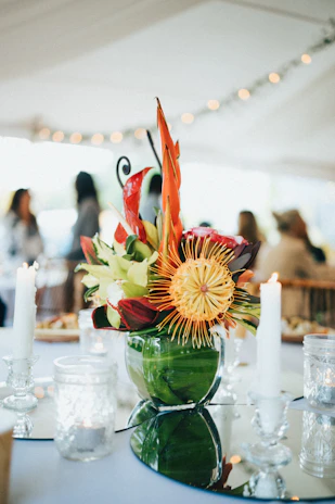 Floral centerpiece with vibrant seasonal blooms decorating an elegant event space.