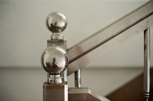 Close-up of sleek iron railings with a smooth finish along a staircase.