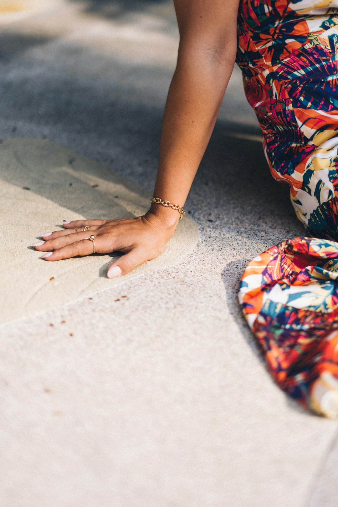 woman in red white and blue floral dress with gold ring