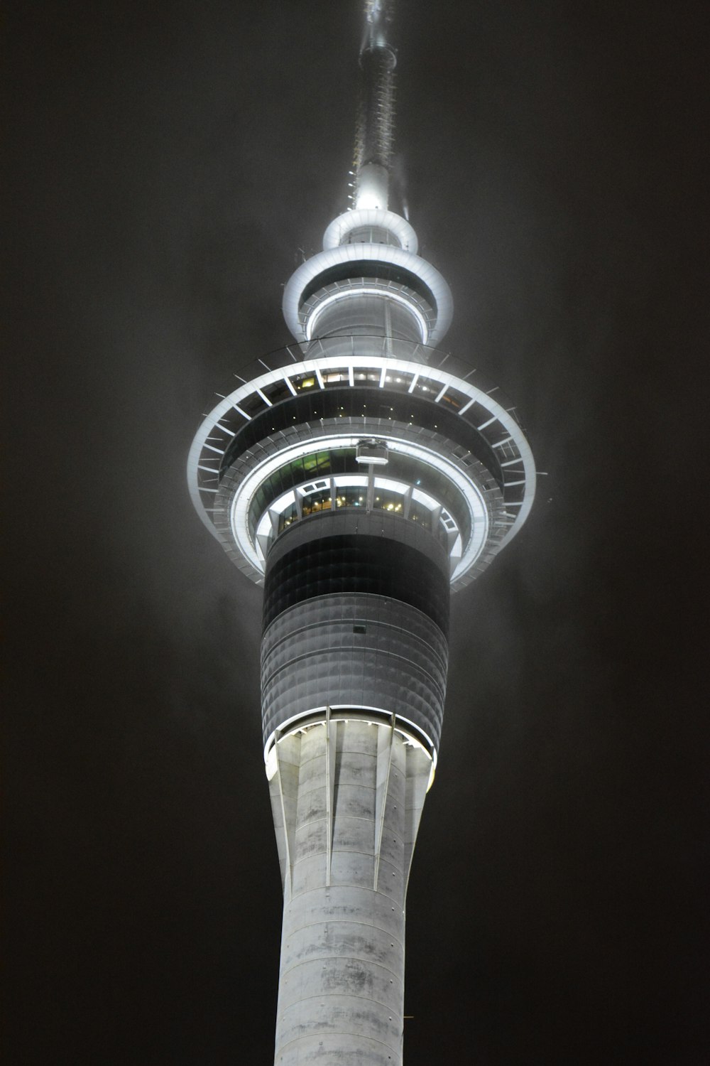 white and black tower under gray sky