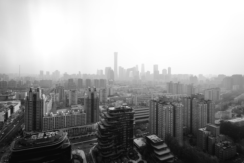 grayscale photo of city buildings during daytime