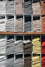 white and yellow textiles on brown wooden shelf