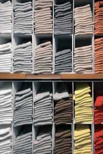 white and yellow textiles on brown wooden shelf