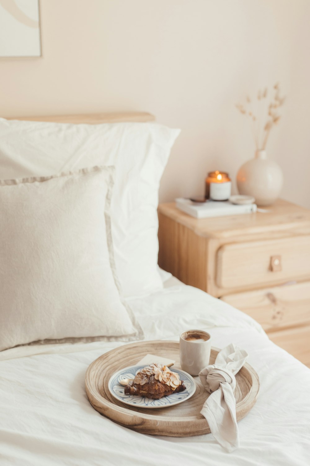 white and brown ceramic mug on brown wooden round table