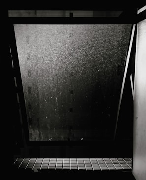 Exterior window on a high-rise building covered in dust and grime before service.