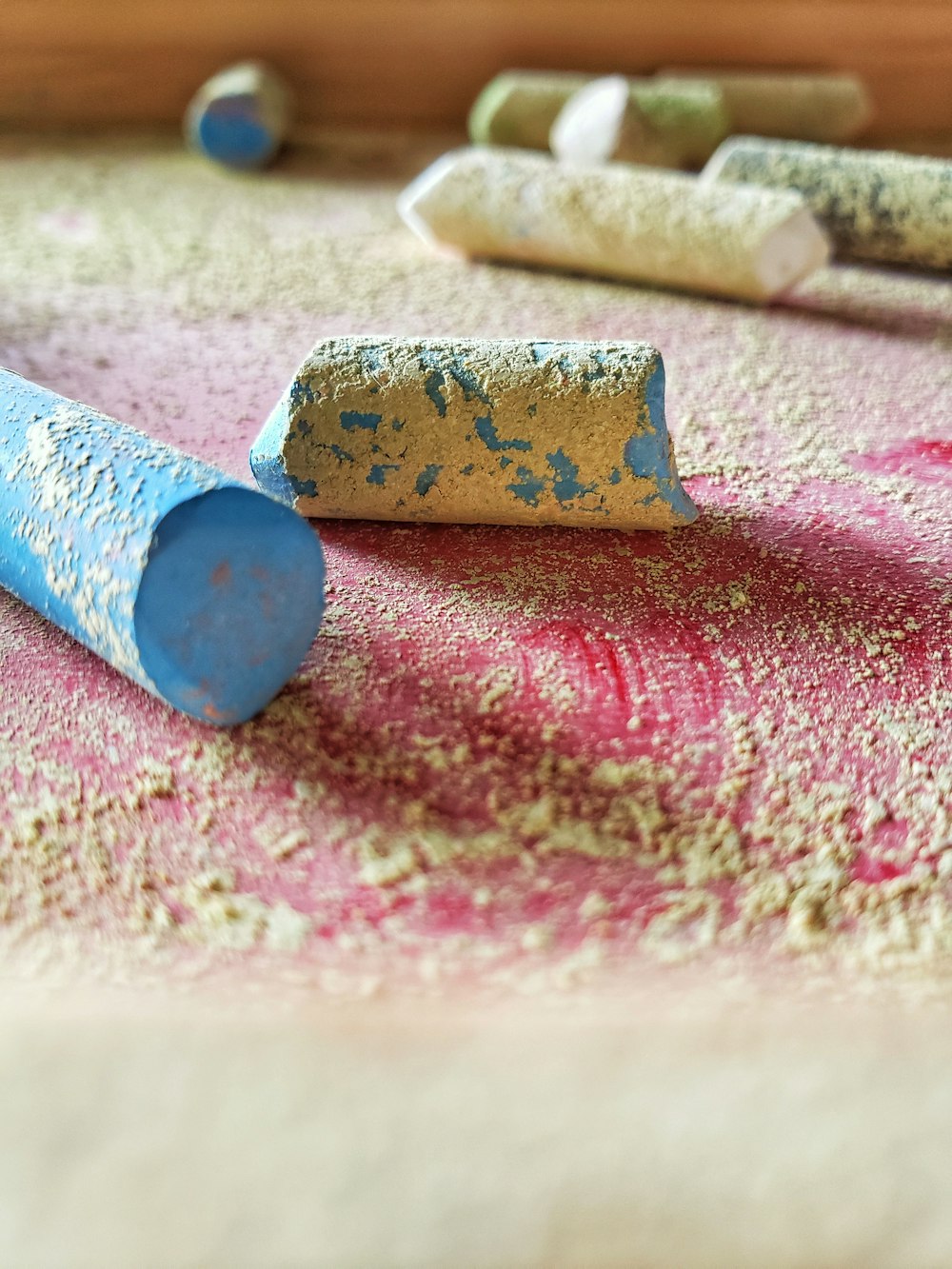 blue and brown rolled paper on pink and white textile