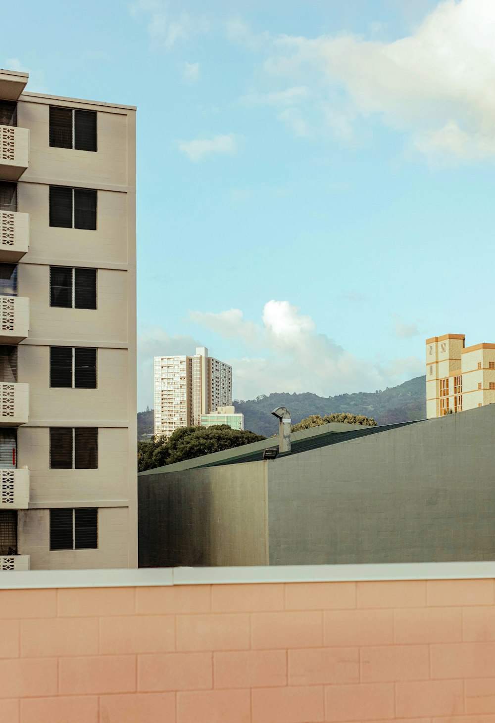 white concrete building near green trees during daytime