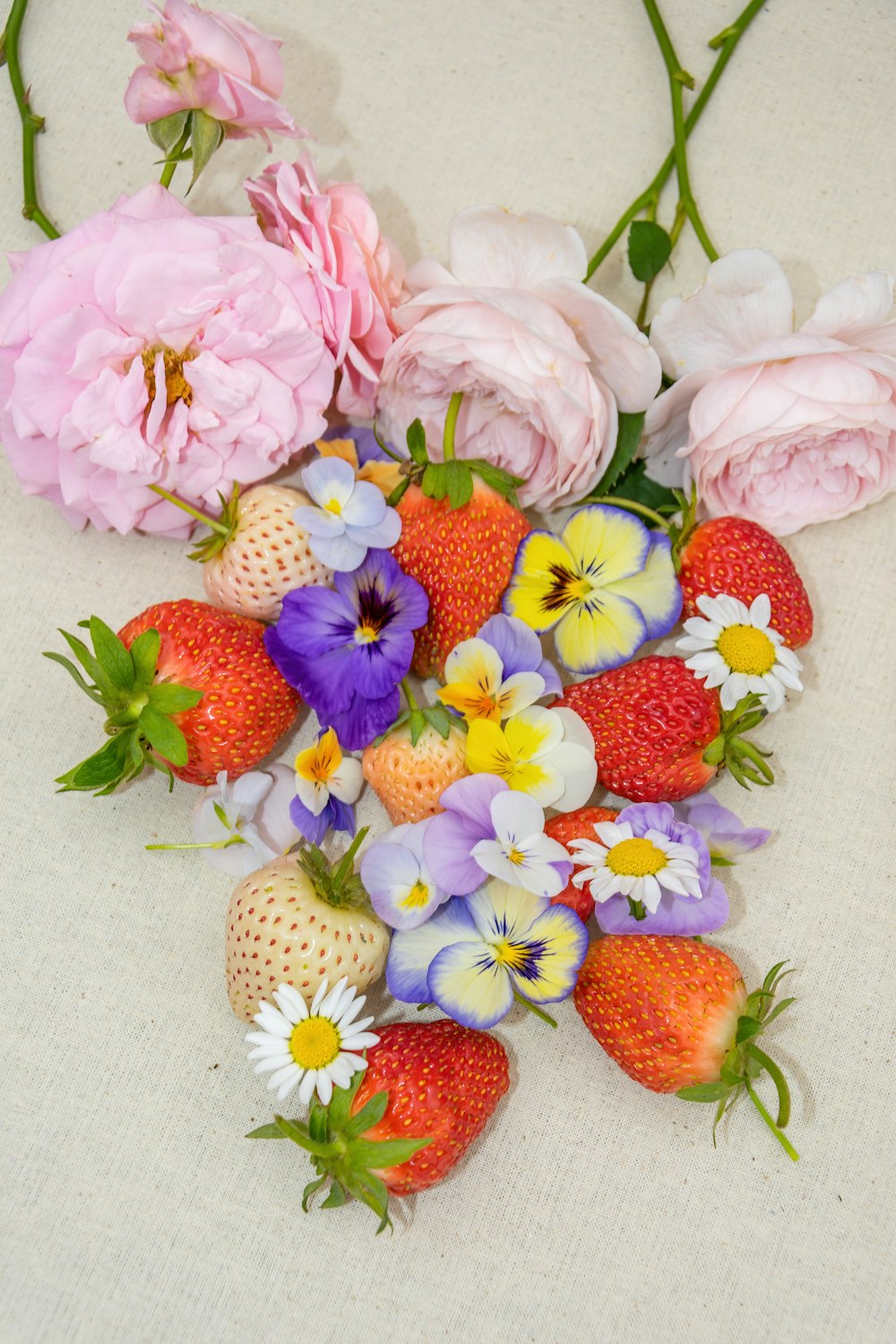 pink and white flowers on white textile