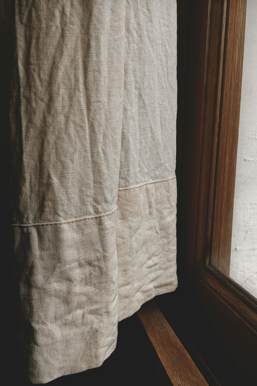 gray textile near brown wooden door