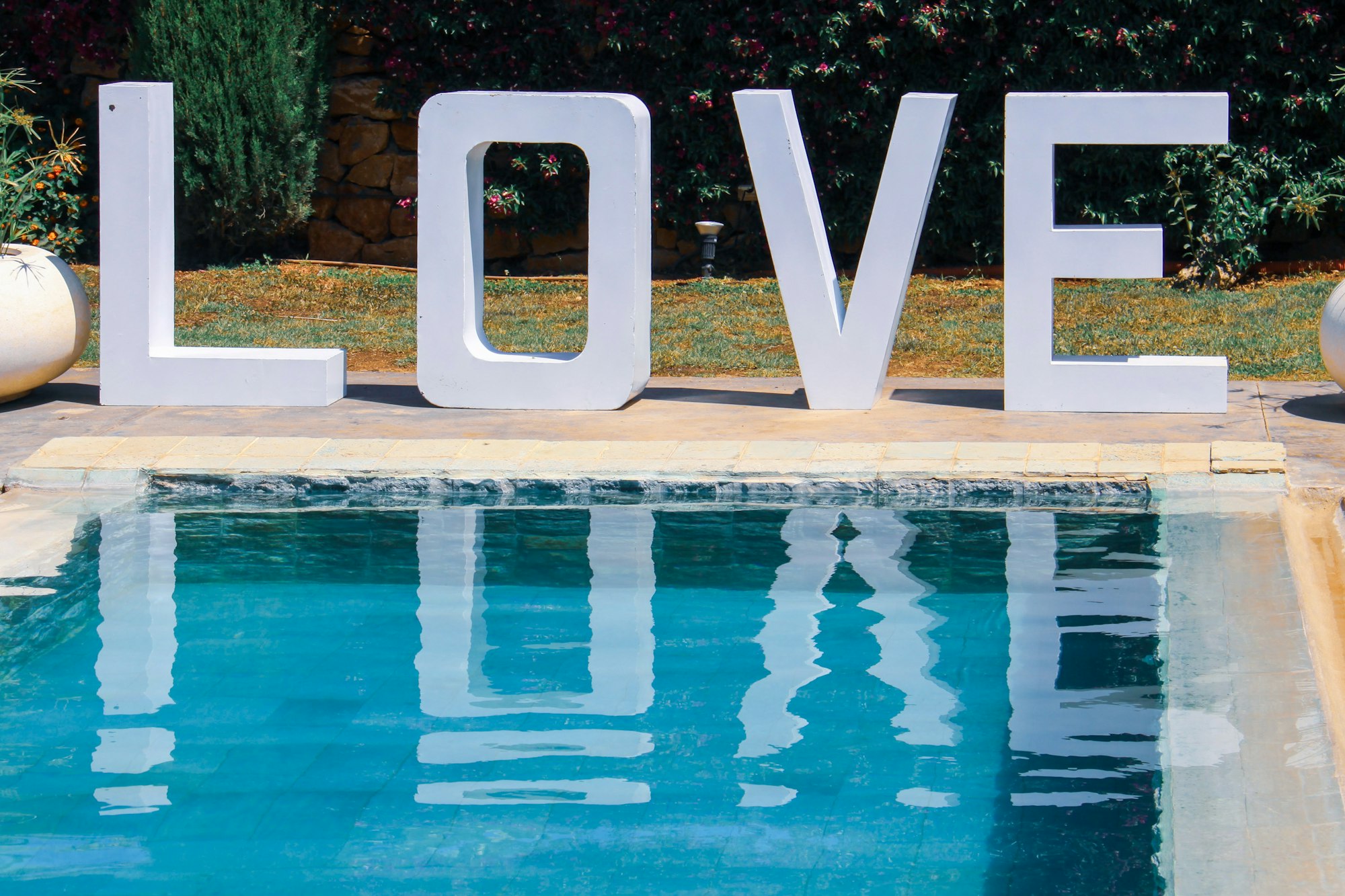 The word love, reflected in a swimming pool.