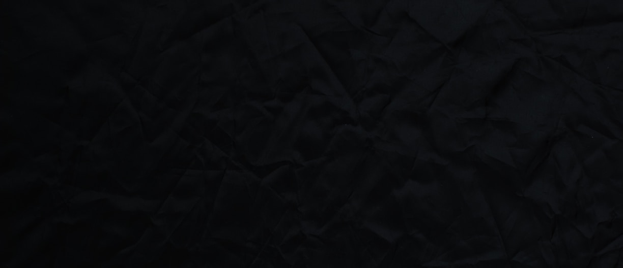 black textile on brown wooden table